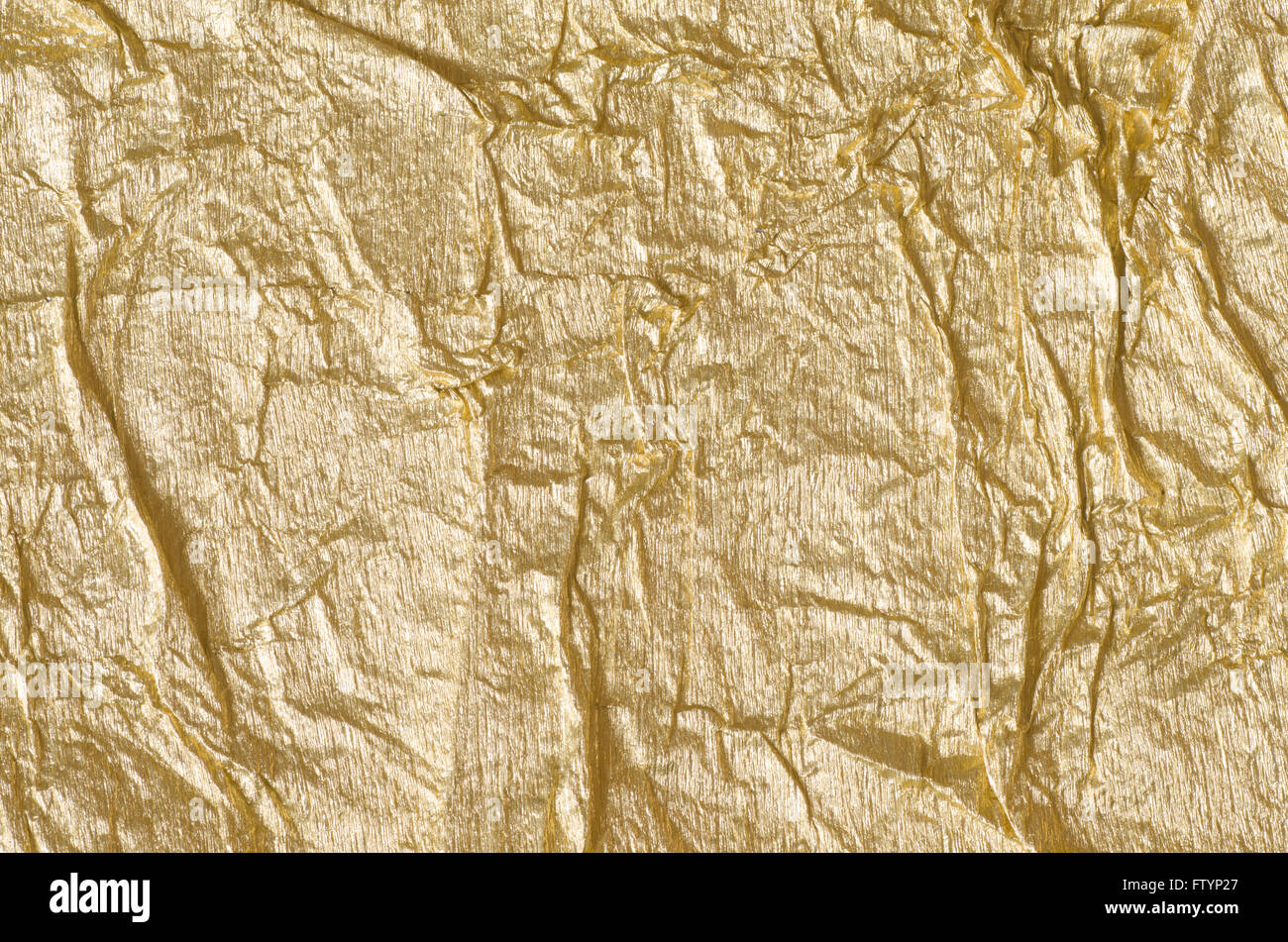 Crumpled Aluminum Foil Background Texture - in Gold Color Stock Photo