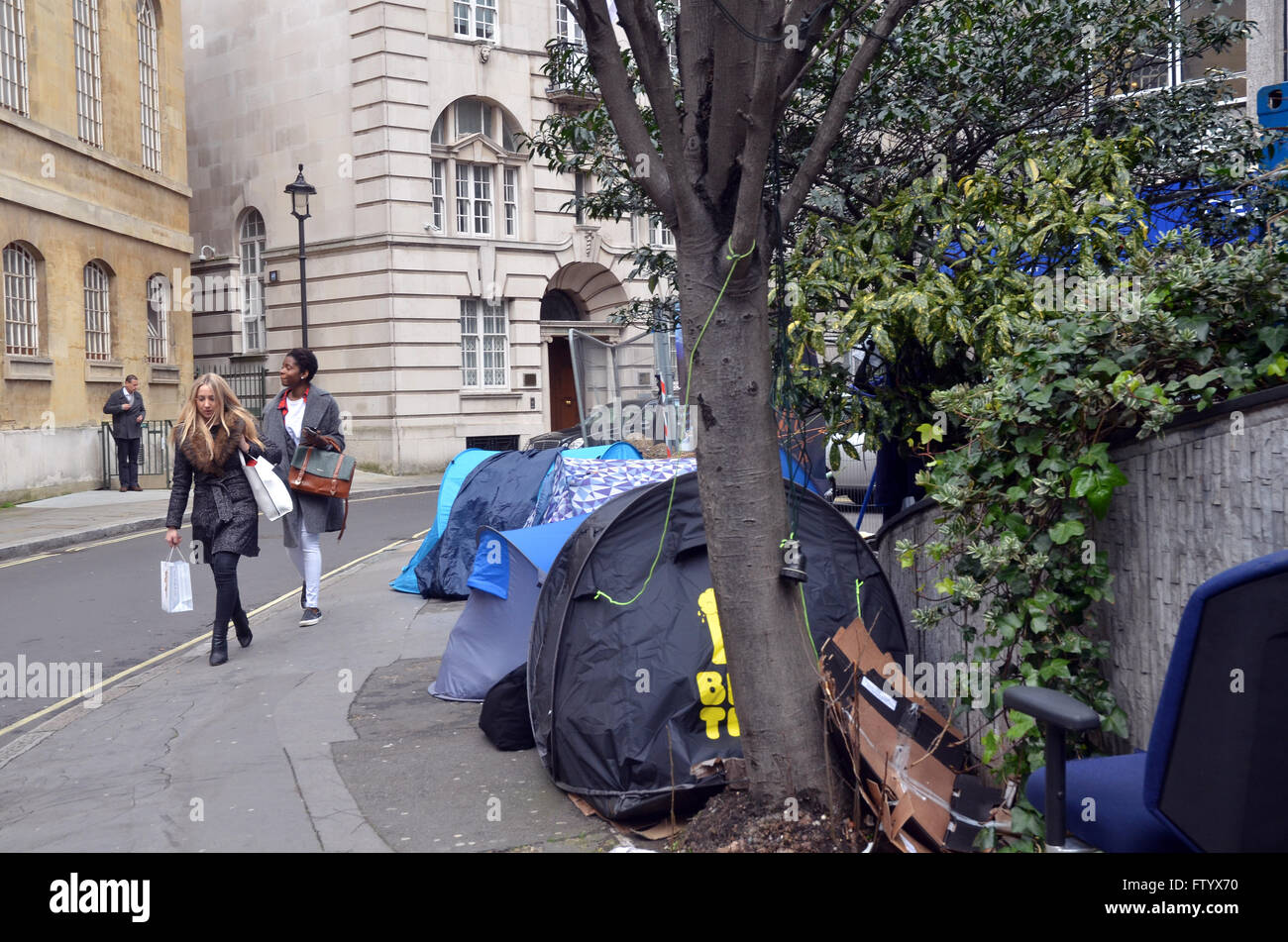 London, UK, 30 March 2016, Pedestrians pass the homeless tents