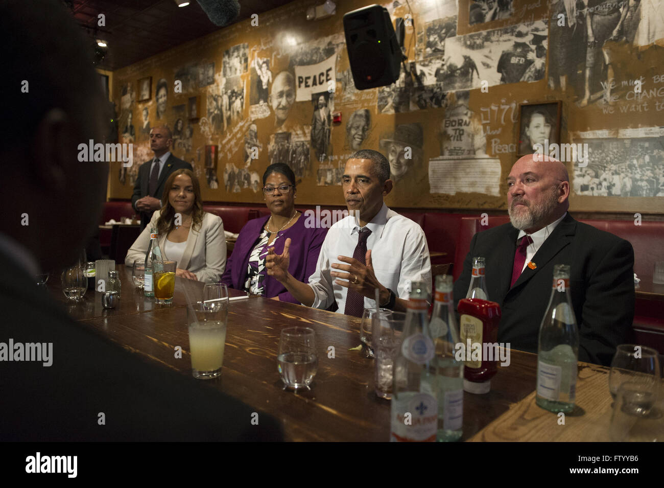 Washington, District of Columbia, USA. 30th Mar, 2016. United States President Barack Obama speaks to the media after having lunch with formerly incarcerated individuals who have received commutations, at Bus Boys and Poets restaurant in Washington, DC on March 30, 2016. Obama commuted 61 additional sentences today.Credit: Kevin Dietsch/Pool via CNP © Kevin Dietsch/CNP/ZUMA Wire/Alamy Live News Stock Photo