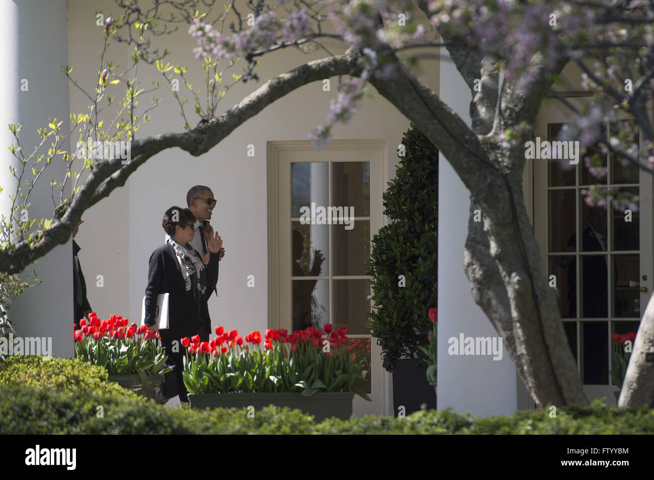 Washington, District of Columbia, USA. 30th Mar, 2016. United States President Barack Obama and Senior Advisor Valerie Jarrett walk to the Oval Office after having lunch with formerly incarcerated individuals who have received commutations, in Washington, DC on March 30, 2016. Credit: Kevin Dietsch/Pool via CNP © Kevin Dietsch/CNP/ZUMA Wire/Alamy Live News Stock Photo