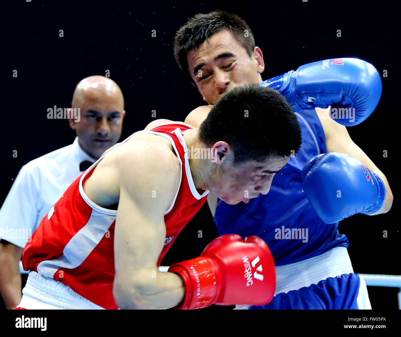 Qian'an, China's Hebei Province. 31st Mar, 2016. Hasanboy Dusmatov(R) of Uzbekistan competes with Gan-Erdene Gankhuyag of Mongolia during their men's 64kg category of Asia/Oceania Zone boxing event qualifier for 2016 Rio Olympic Games in Qian'an, north China's Hebei Province, March 31, 2016. Hasanboy Dusmatov won the match 3-0. © Yang Shiyao/Xinhua/Alamy Live News Stock Photo