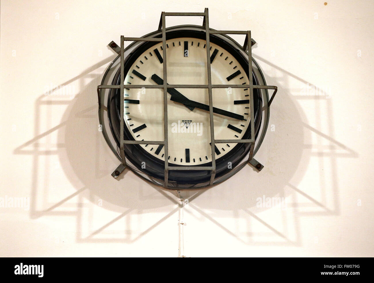 A barred clock pictured in the prison gymnasium of the correctional