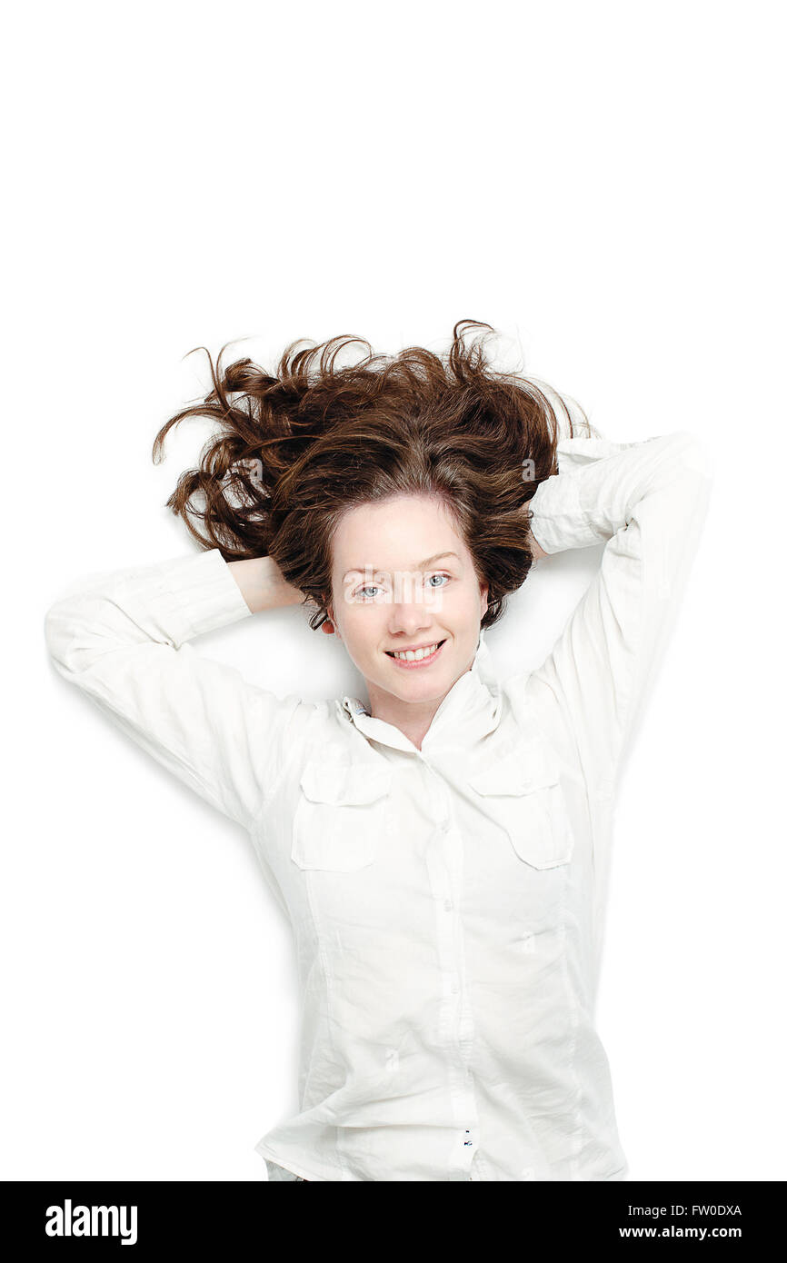 Smiling girl lying on her back Stock Photo - Alamy