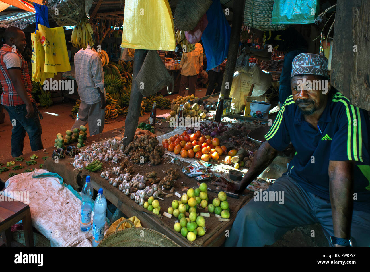 Sale of limes, tomatoes and different types of vegetables in the Stone Town market, Zanzibar, Tanzania. Stock Photo