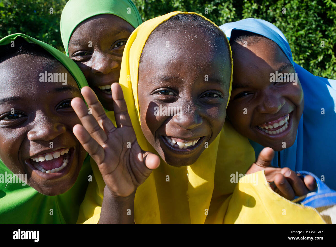 Young girls dressed with colorful clothing in Kizimkazi Dimbani village, West coast, Zanzibar, Tanzania. Stock Photo