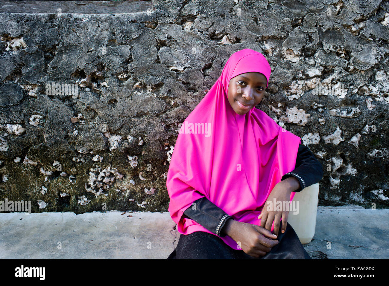 Young girl dressed with pink clothing in Kizimkazi Dimbani village, West coast, Zanzibar, Tanzania. Stock Photo