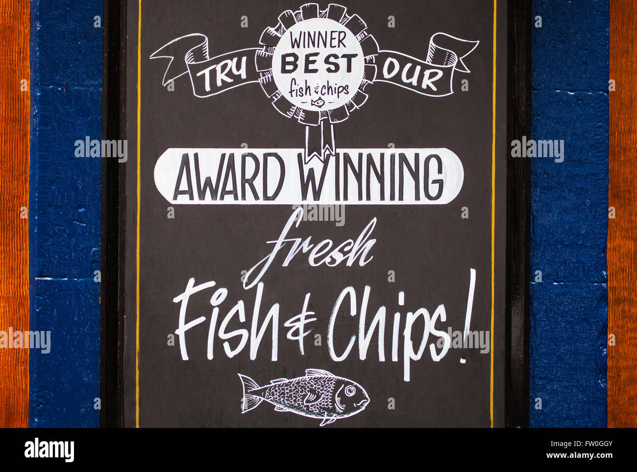 A board outside a vintage pub advertising fresh Fish and Chips - a traditional British meal. Stock Photo