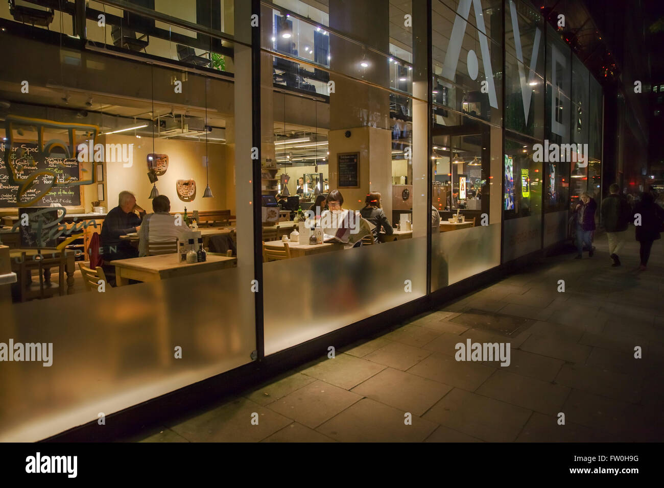 Night scene: London, England, a restaurant front, respectfully shot in the style of 'Nighthawk' by Edward Hopper Stock Photo