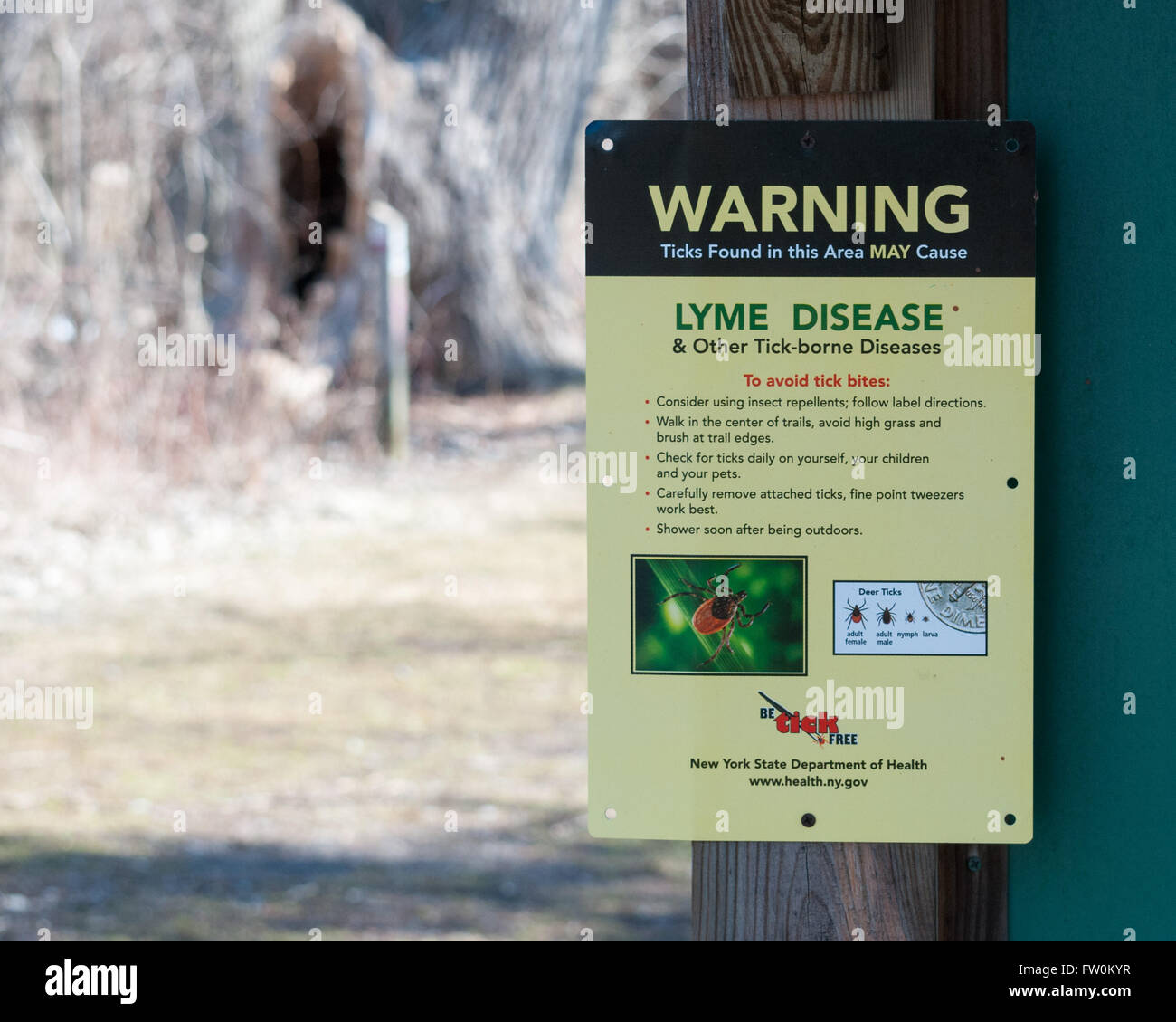 Deer Tick Warning Sign posted in a nature park in New York State. Stock Photo