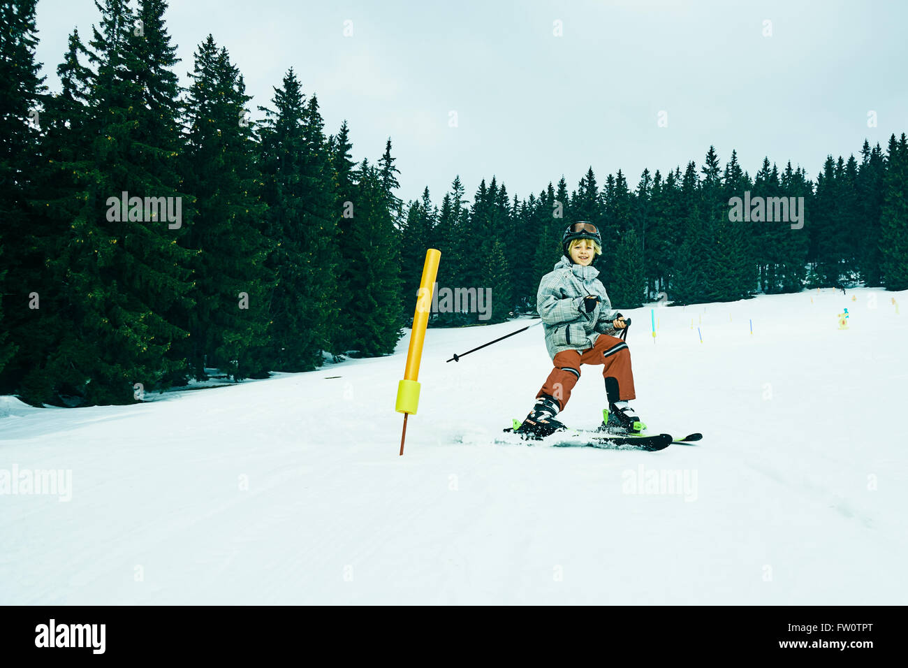 The boy on skis in mountains Stock Photo - Alamy