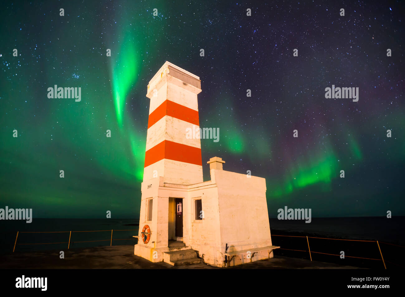 Northern Lights, or Aurora Borealis, display at Gardur Lighthouse, Reykanes Peninsula, Iceland. Stock Photo