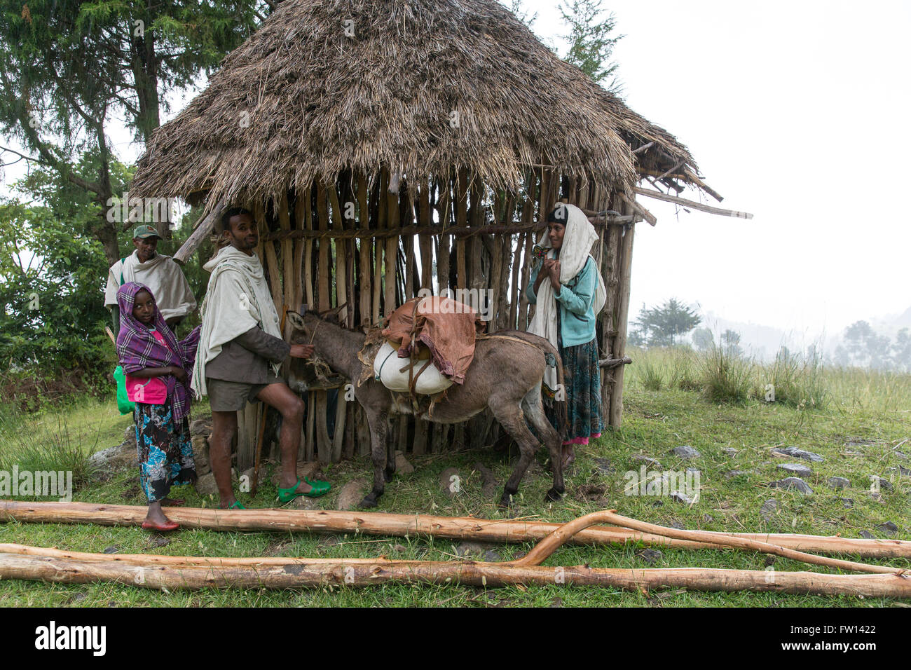 Debre Mahela Kebele, North Shewa,  Ethiopia, October 2013: People take shelter from a passing rain shower. Stock Photo