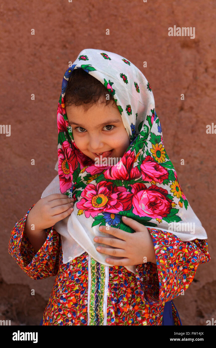 Portrait of iranian little girl wearing the traditional floreal chador, Abyaneh, Iran Stock Photo