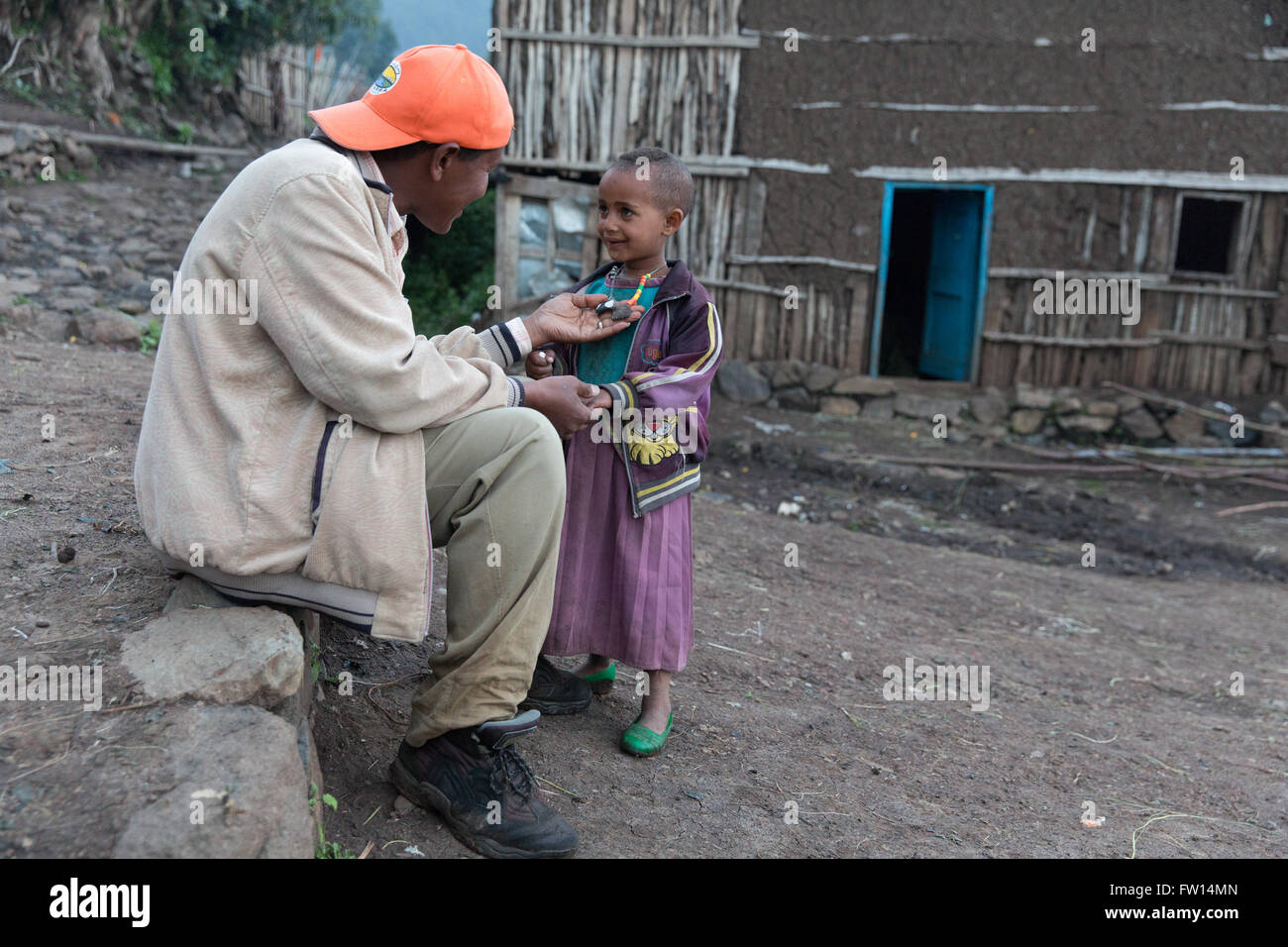 Mescha village,  North Shewa,  Ethiopia, October 2013: Seleshe talking to a child in the village square. Stock Photo