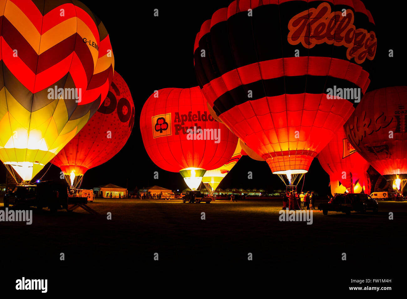 Hot-air balloon night show in Ferrara Italy; the night glow. Hot air balloons light up in time with music. Stock Photo
