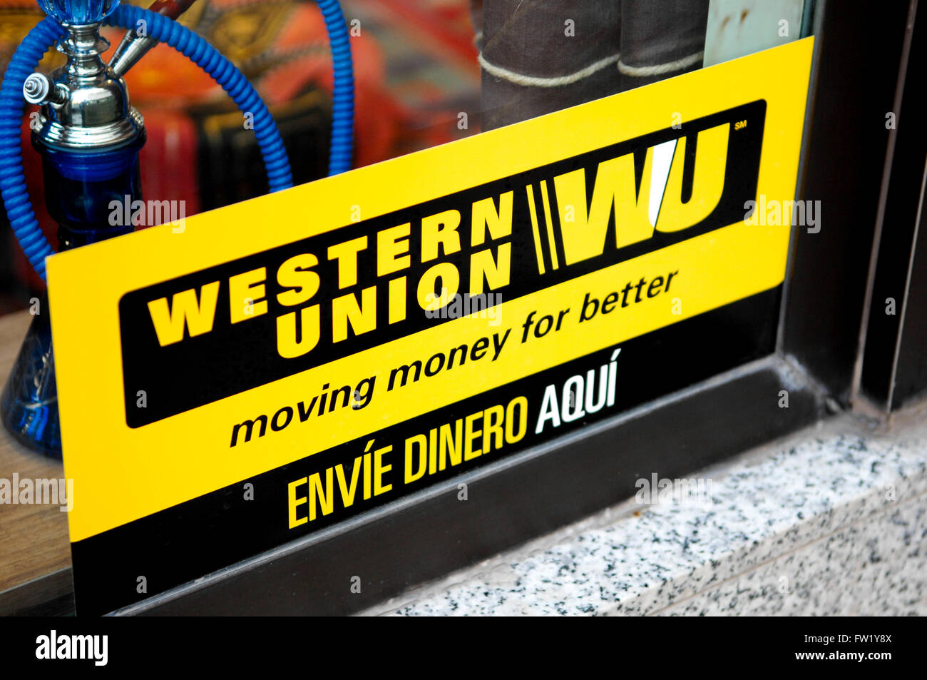 Western Union Sign displayed in shop window of tobacconist in Spain. Stock Photo