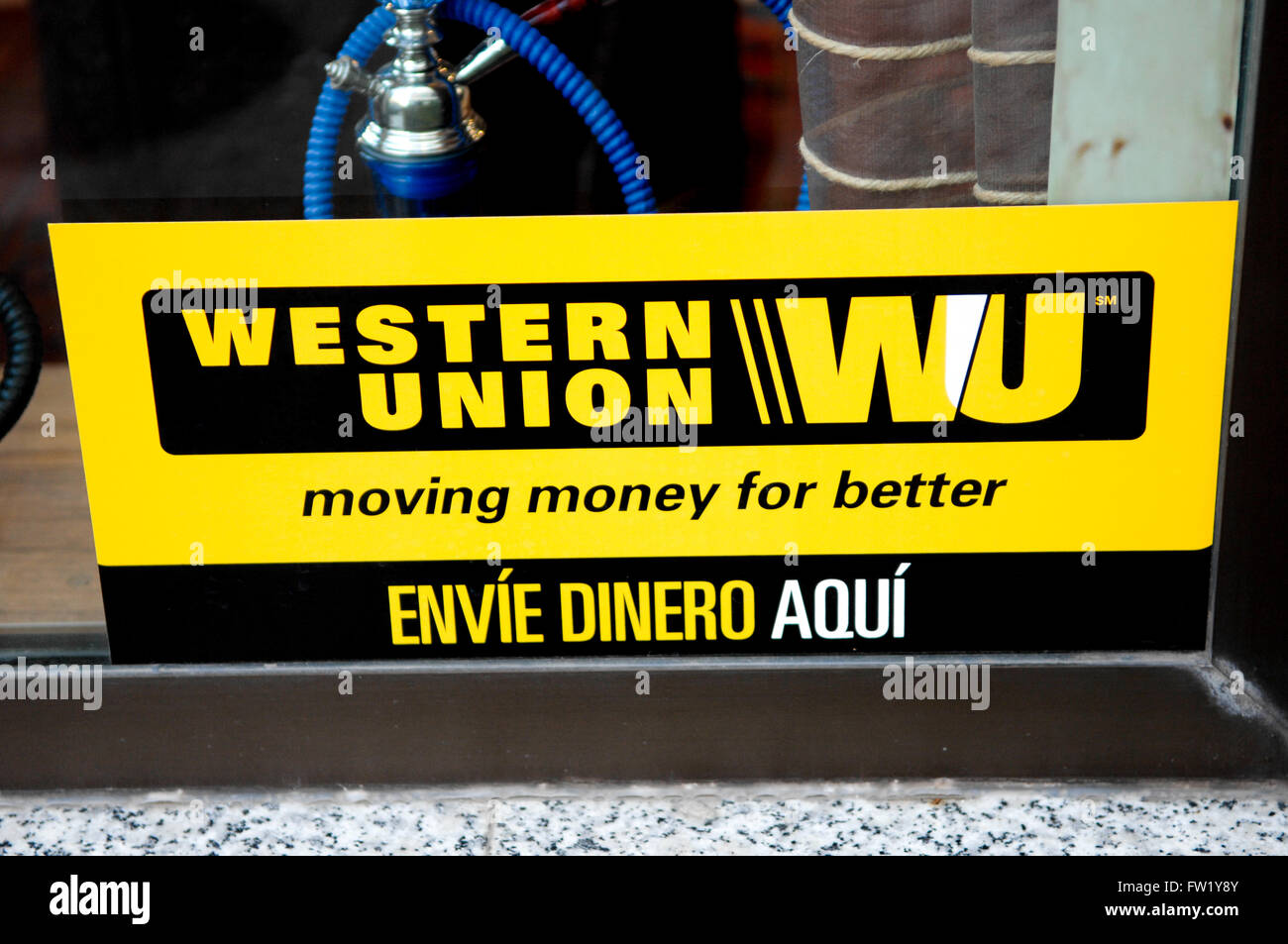 Western Union Sign displayed in shop window of tobacconist in Spain. Stock Photo