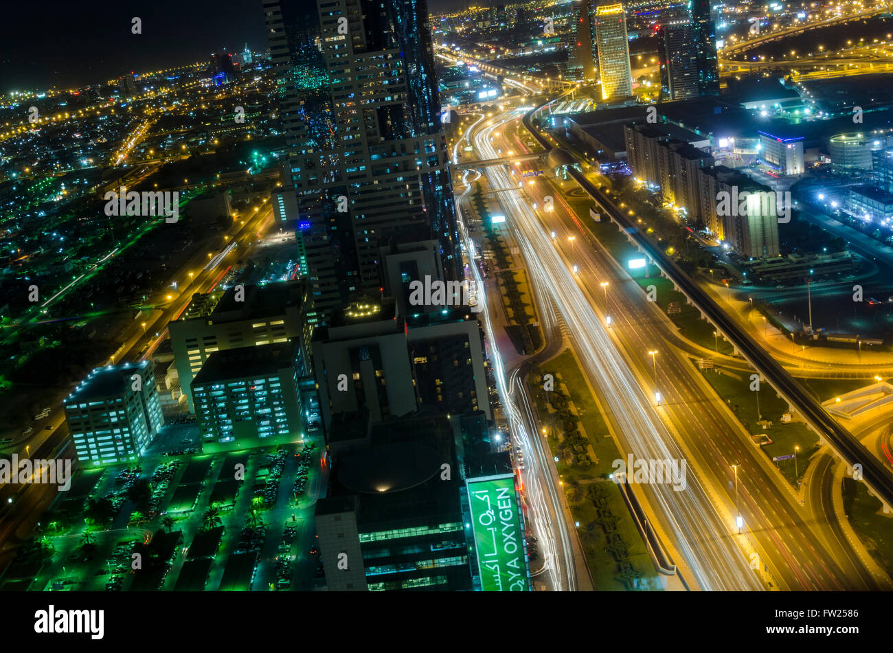 Dubai at night looking East along Sheikh Zayed Road from Emirates Towers Metro Station Stock Photo