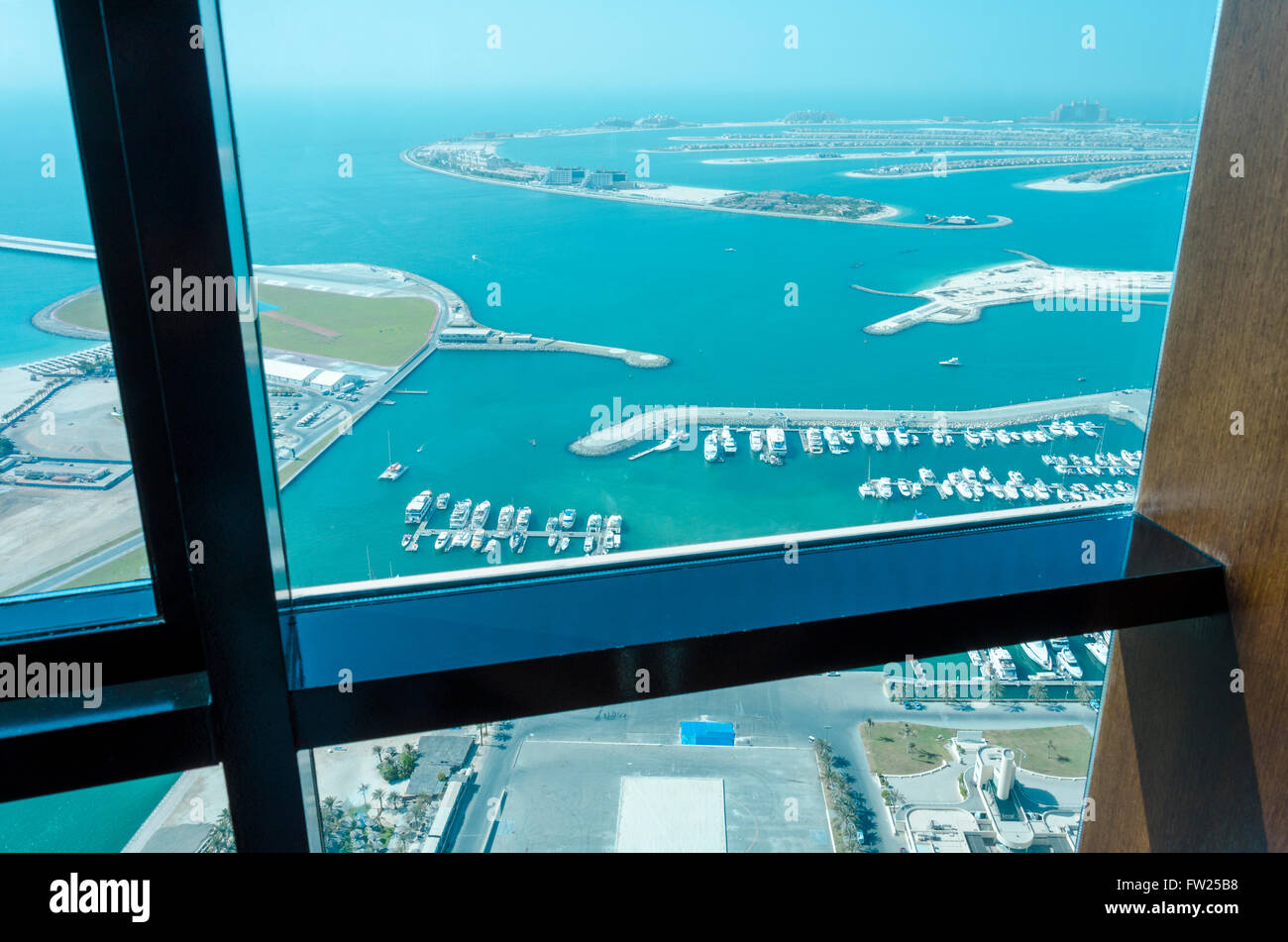 The Palm Jumeirah looking through the window of a skyscraper Stock Photo
