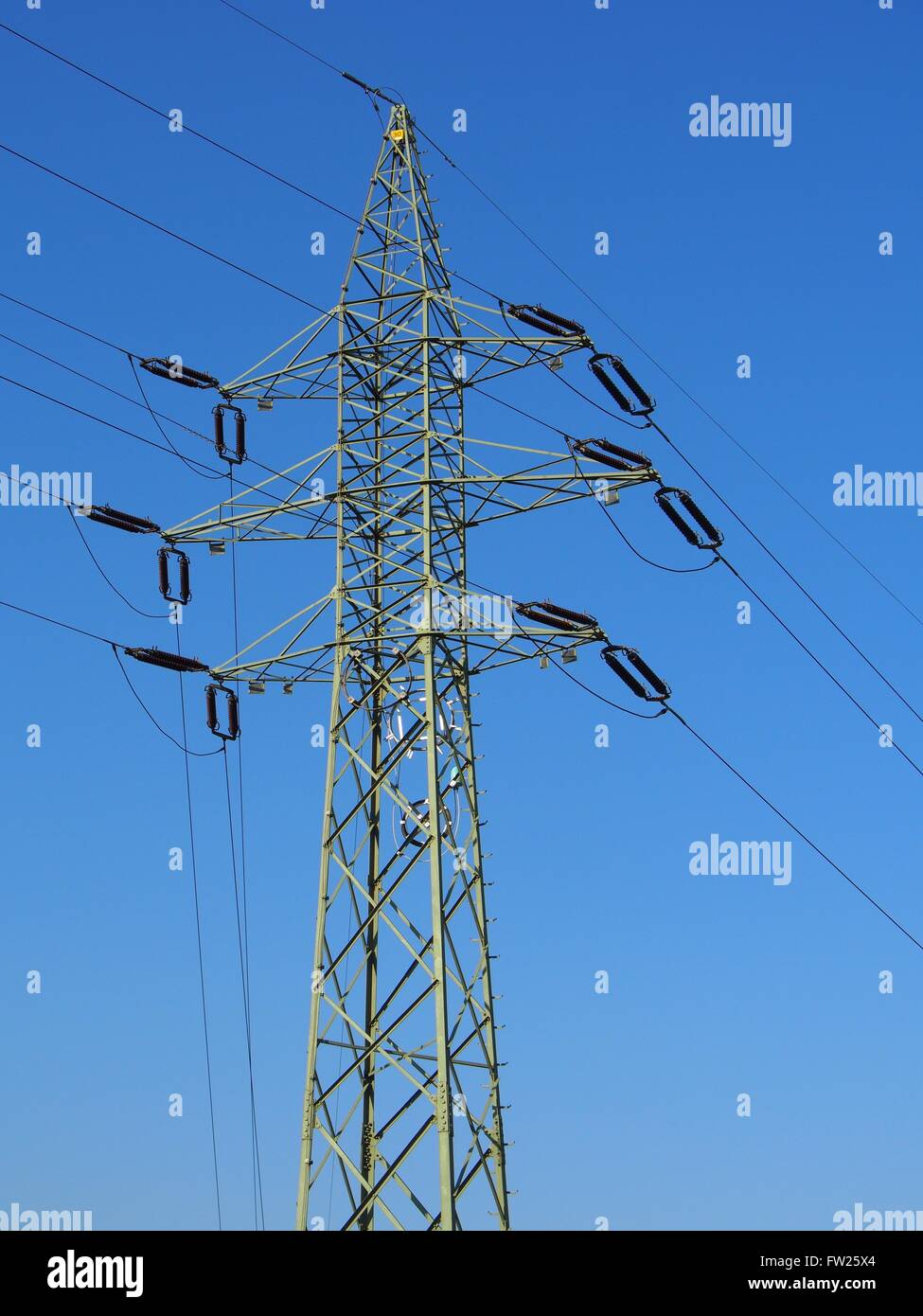 High voltage electric tower against blue sky Stock Photo - Alamy