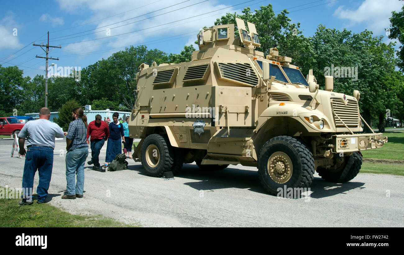 Americus, Kansas, USA, 14th June, 2014  Lyon County Sheriffs show off their newly acquired military surplus Mine Resistant Armored Personnel (MRAP) heavy weapons carrier. Possible use is emergency response to the Wolf Creek Nuclear Power station.  The Annual Americus Days parade takes place on the 3 blocks of Main St.  Americus is a city in Lyon County, Kansas, United States. As of the 2010 census, the city population was 896. It is part of the Emporia Micropolitan Statistical Area. Credit: Mark Reinstein Stock Photo
