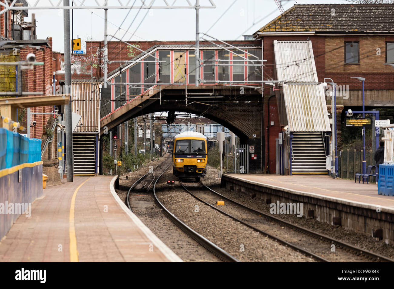 Diesel train approaching the platform under a tunnel at West Ealing station in London Stock Photo