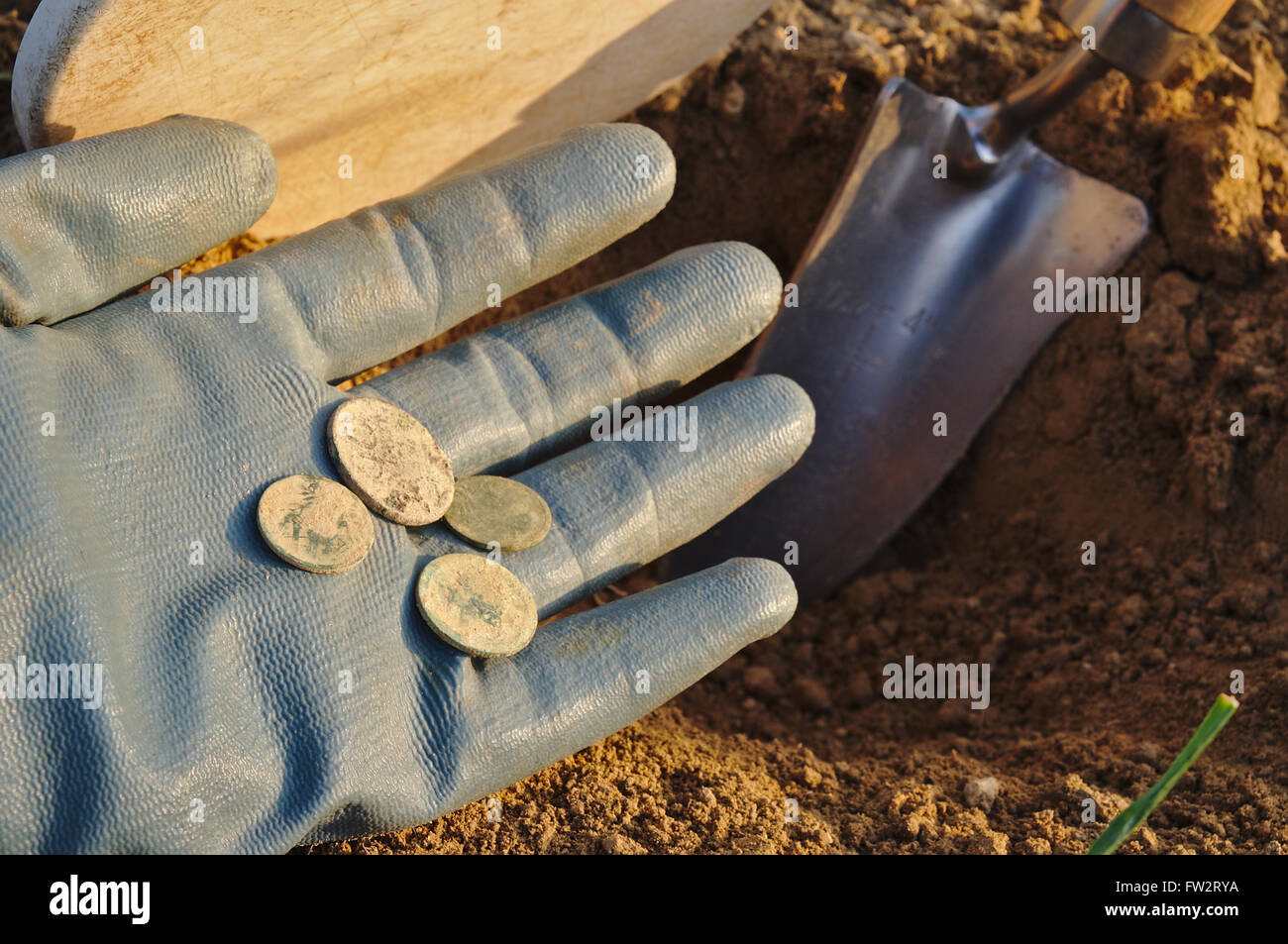Metal detecting and treasure hunting. Metal detector, spade and gloves. Sports and hobbies theme Stock Photo
