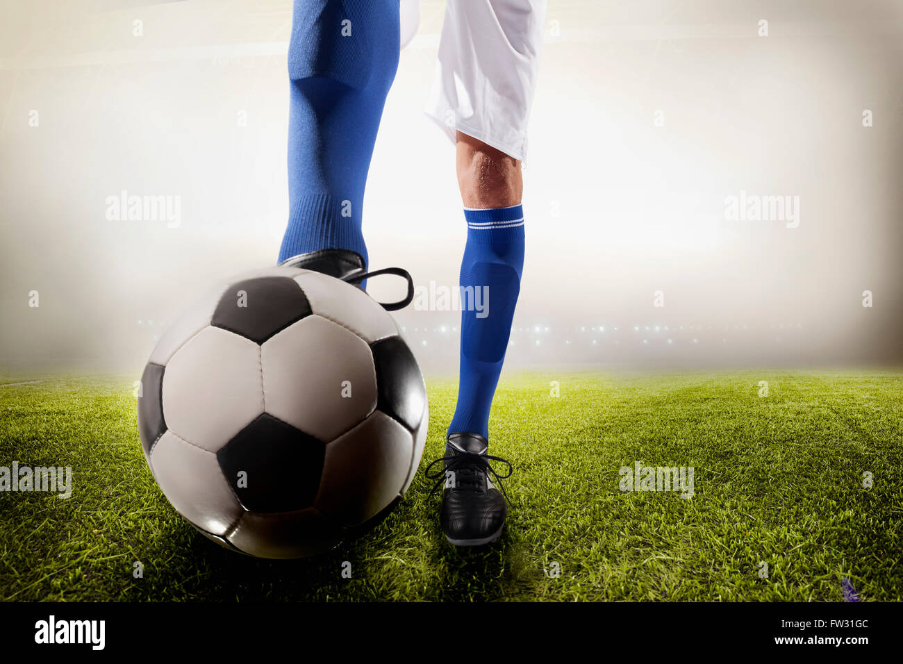 Athlete kicking soccer ball Stock Photo - Alamy