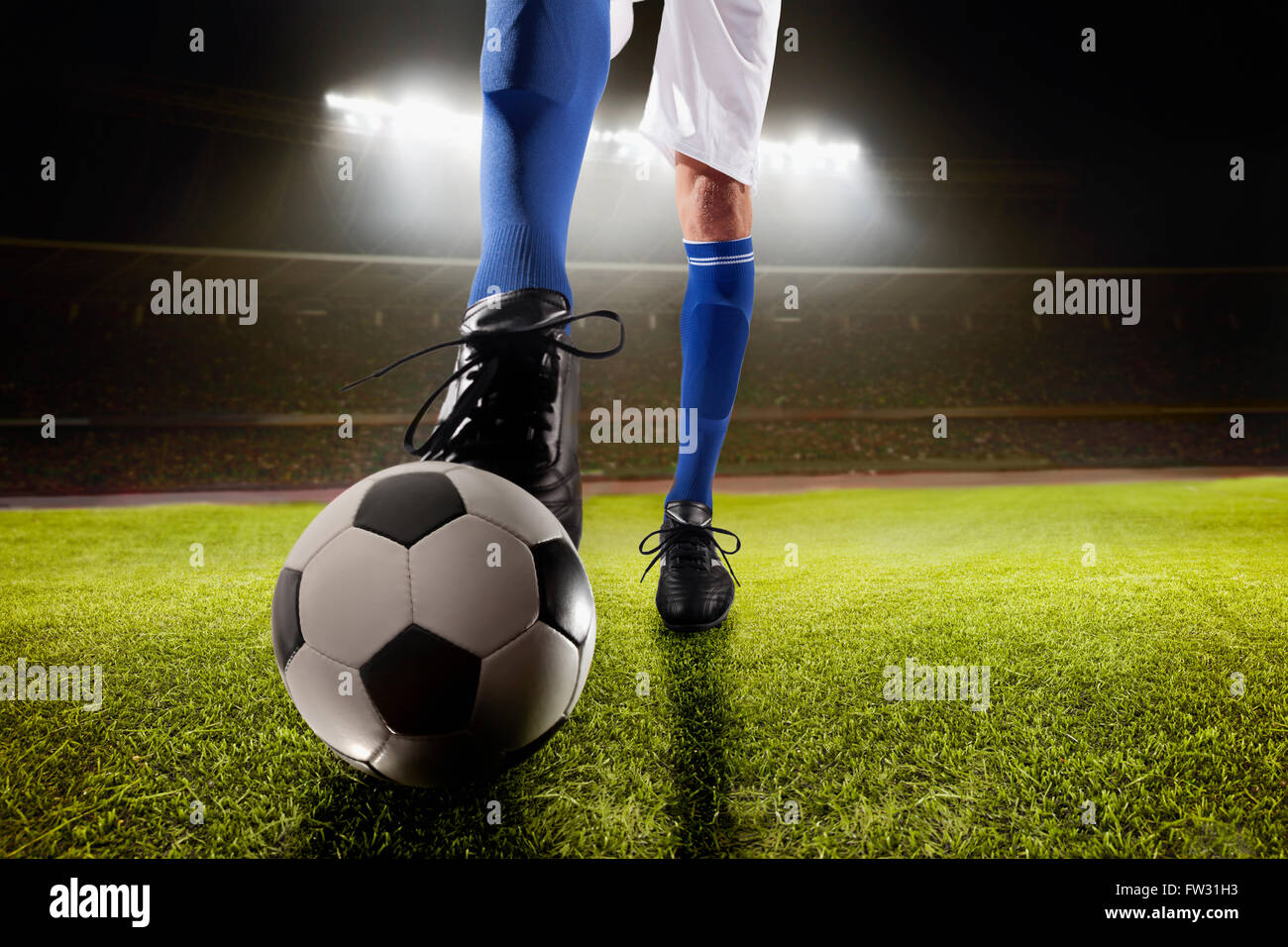 Athlete kicking soccer ball Stock Photo - Alamy