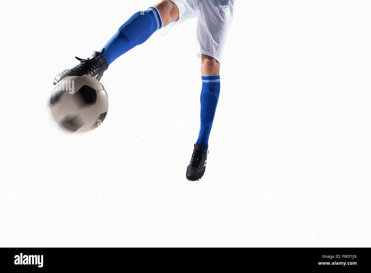 Athlete kicking soccer ball Stock Photo - Alamy