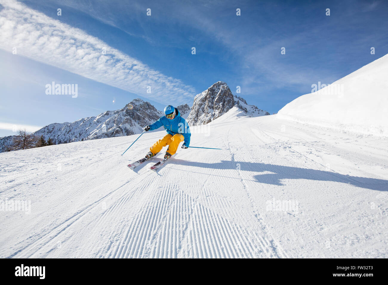 Skier with a helmet skiing down a slope, Mutterer Alm near Innsbruck