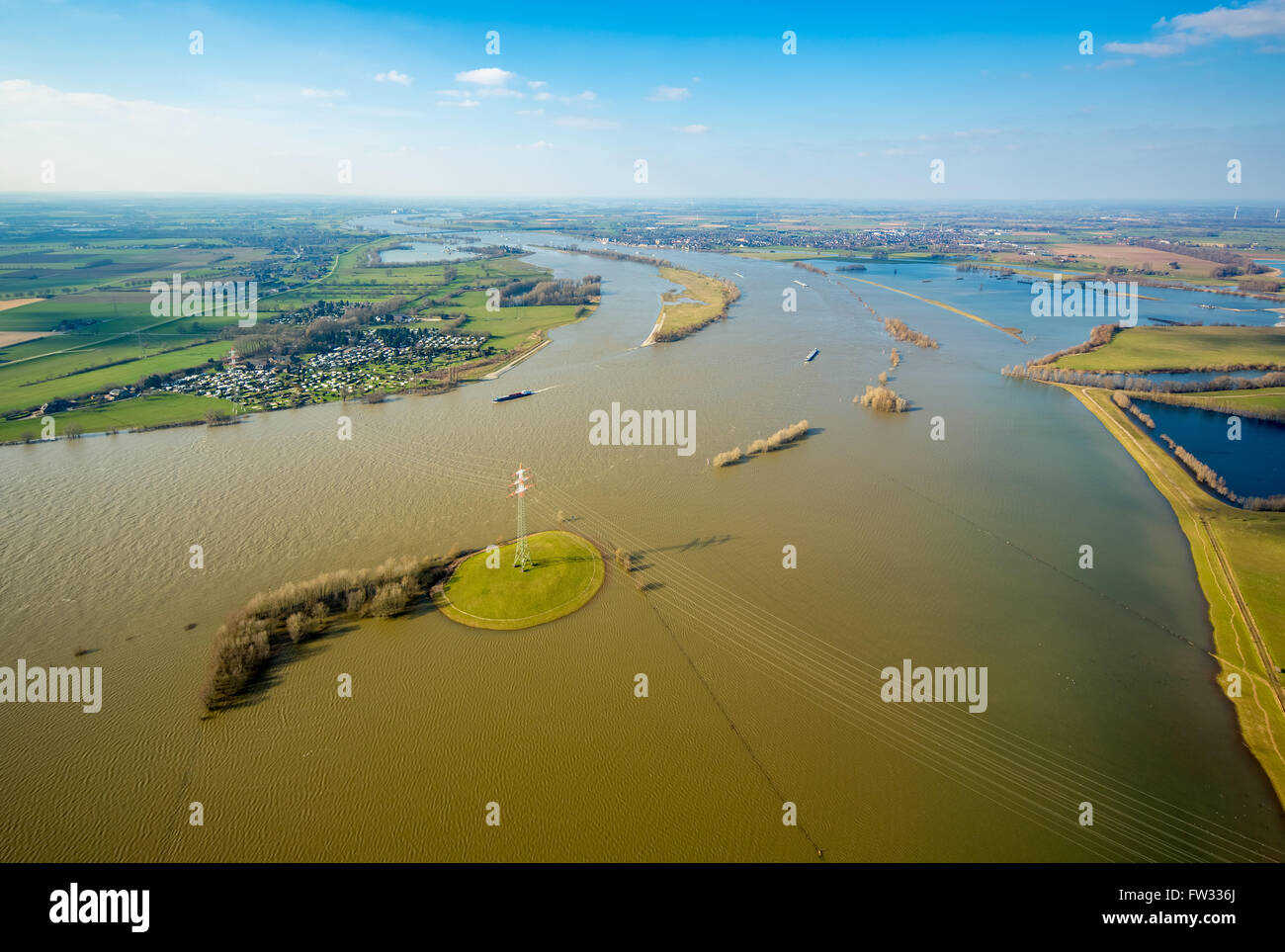 Aerial view of the Rhine floods and overhead power line standing on an island in the water between Wesel and Rees, Lower Rhine Stock Photo