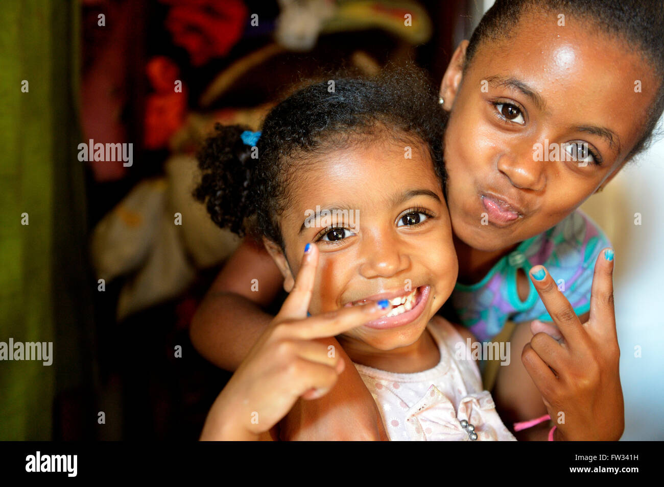 Two girls, 3 and 10 years, in a favela, Favela 21 de Abril, São Paulo, Brazil Stock Photo