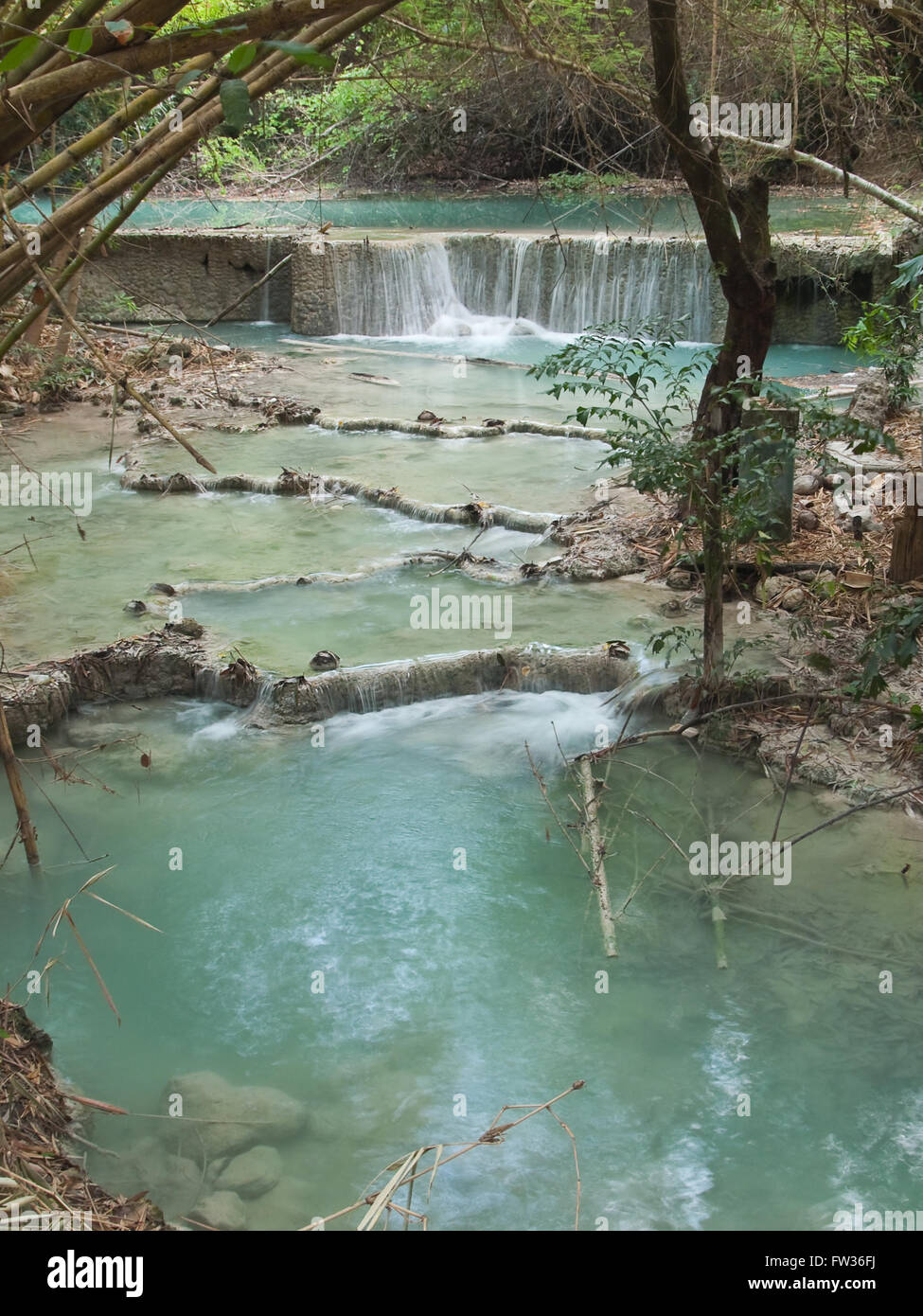 Small waterfall with emerald color water Stock Photo