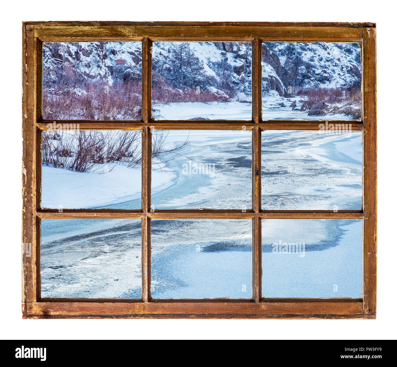 Frozen mountain river as seen through vintage, grunge, sash window with ...