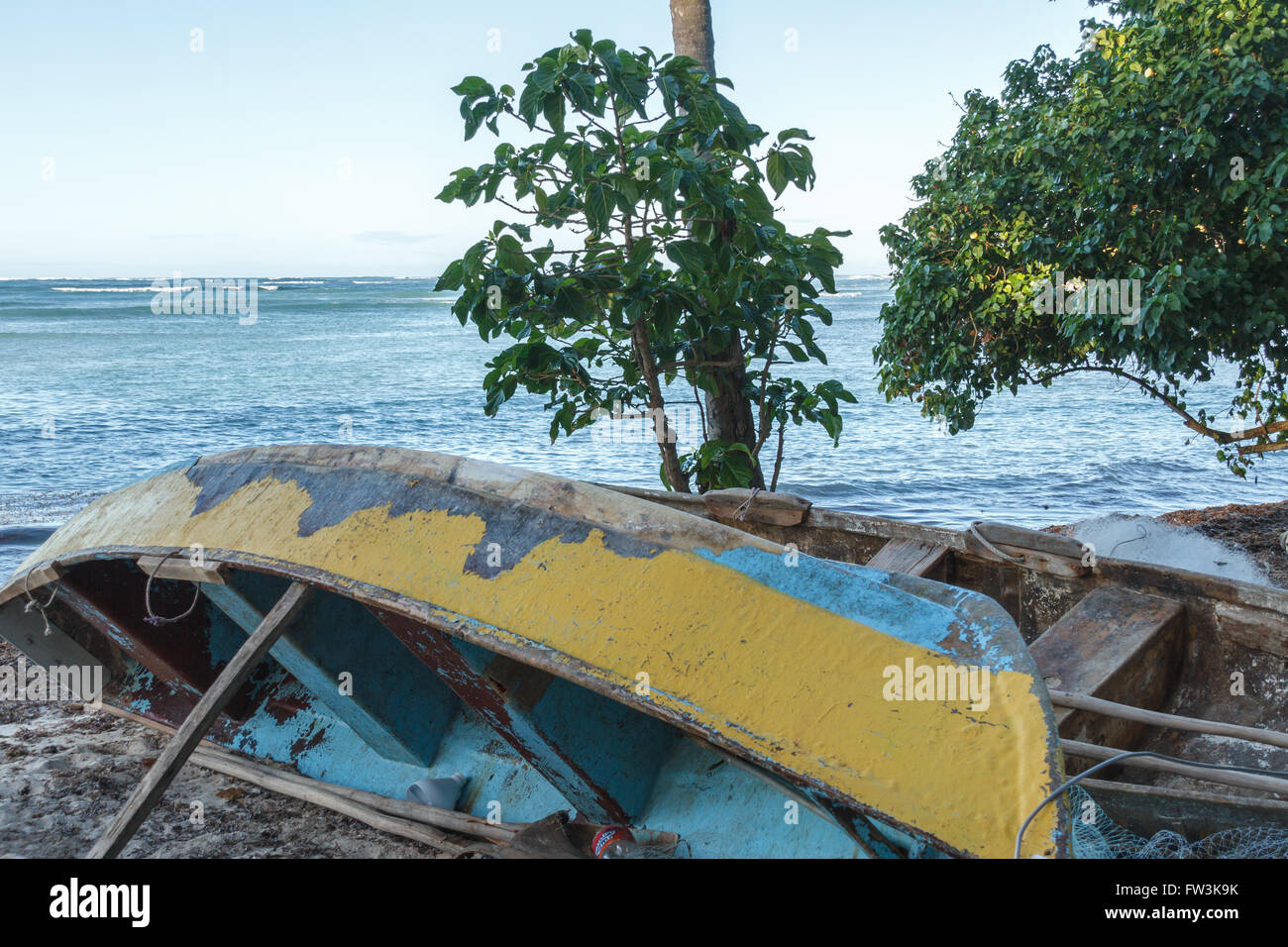 Old fishing boats on the shore at a beach in the Dominican Republic Stock Photo