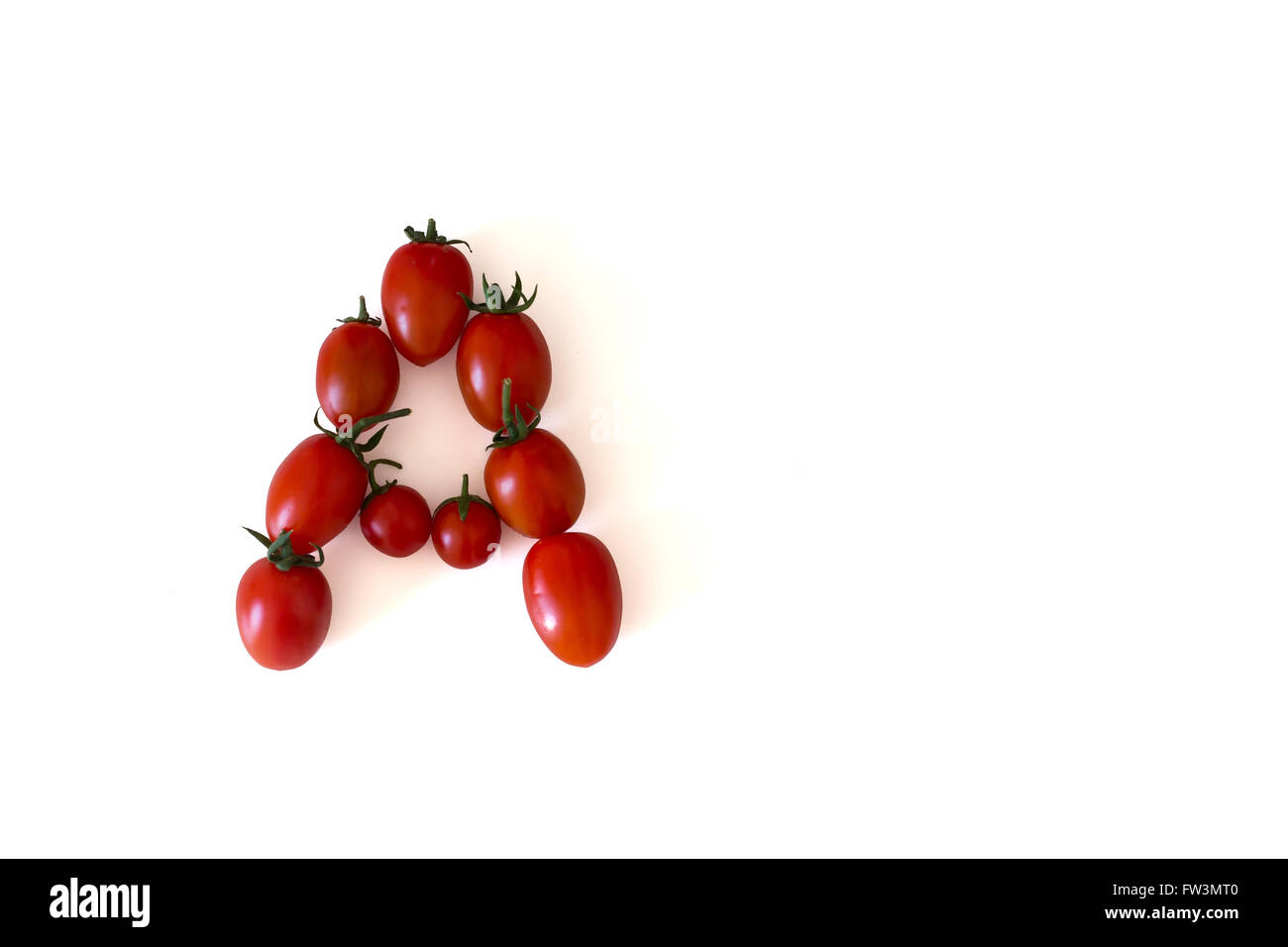 Letter A made out of small bright tomatoes Stock Photo