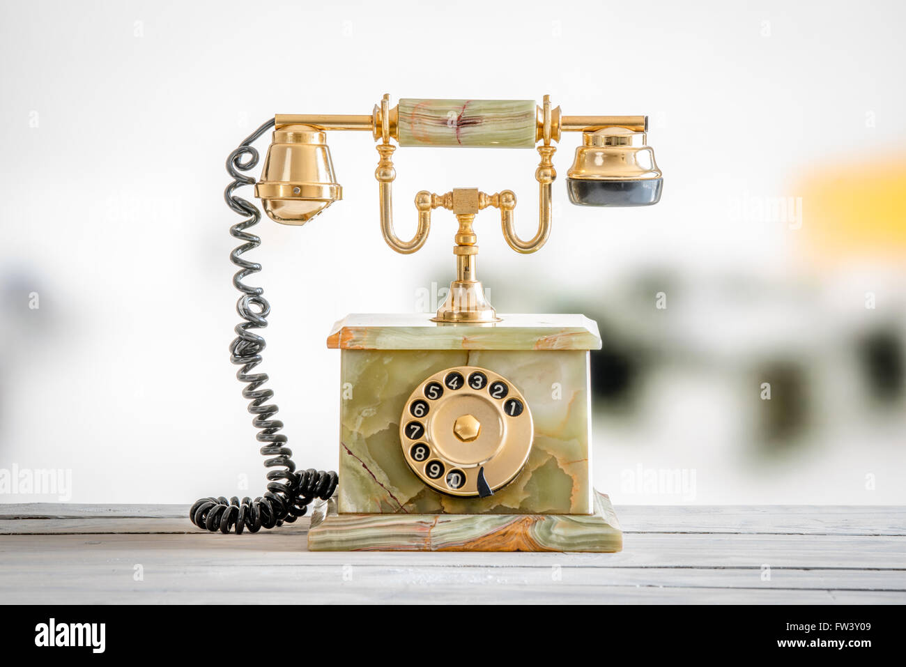 Antique telephone in gold and marble on a wooden desk Stock Photo - Alamy