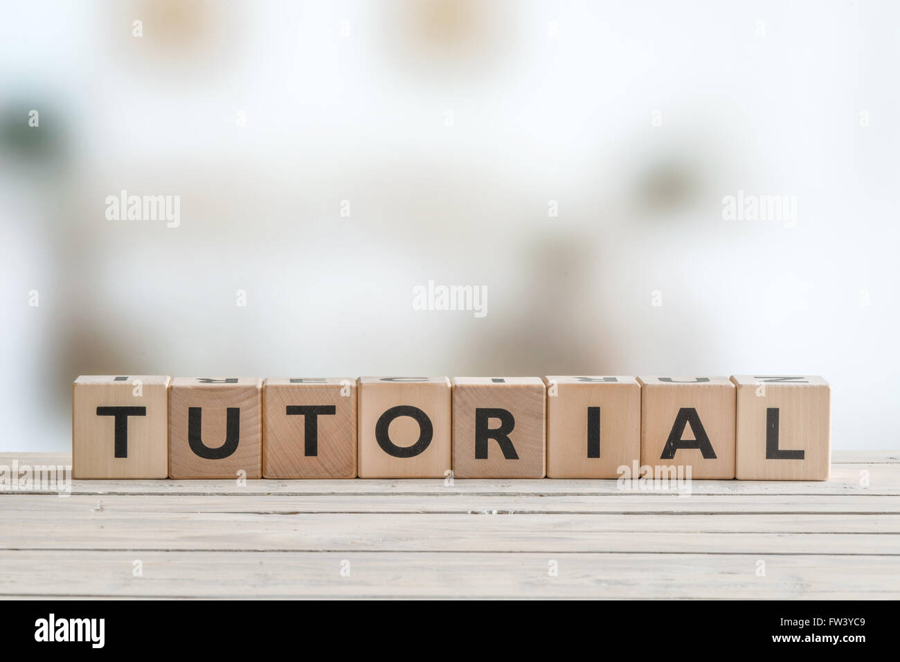 Tutorial sign made of cubes on a wooden table Stock Photo - Alamy