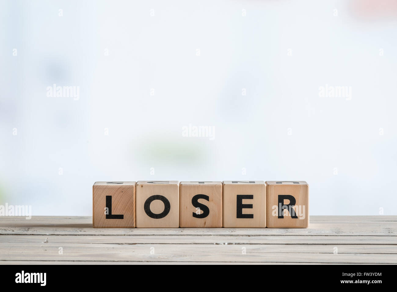 Loser sign made of blocks on a wooden desk Stock Photo