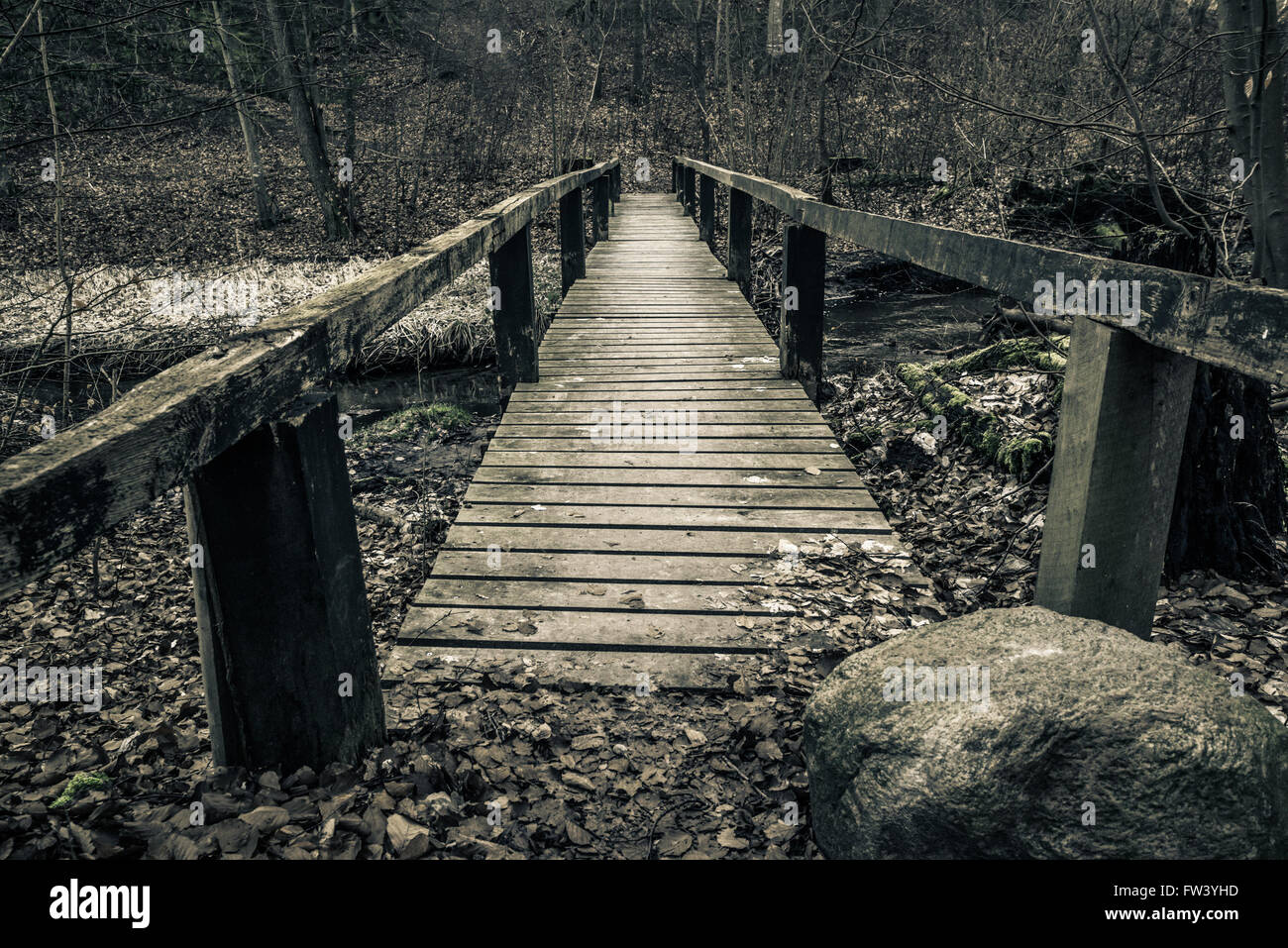 Old wooden bridge with planks in a forest Stock Photo - Alamy