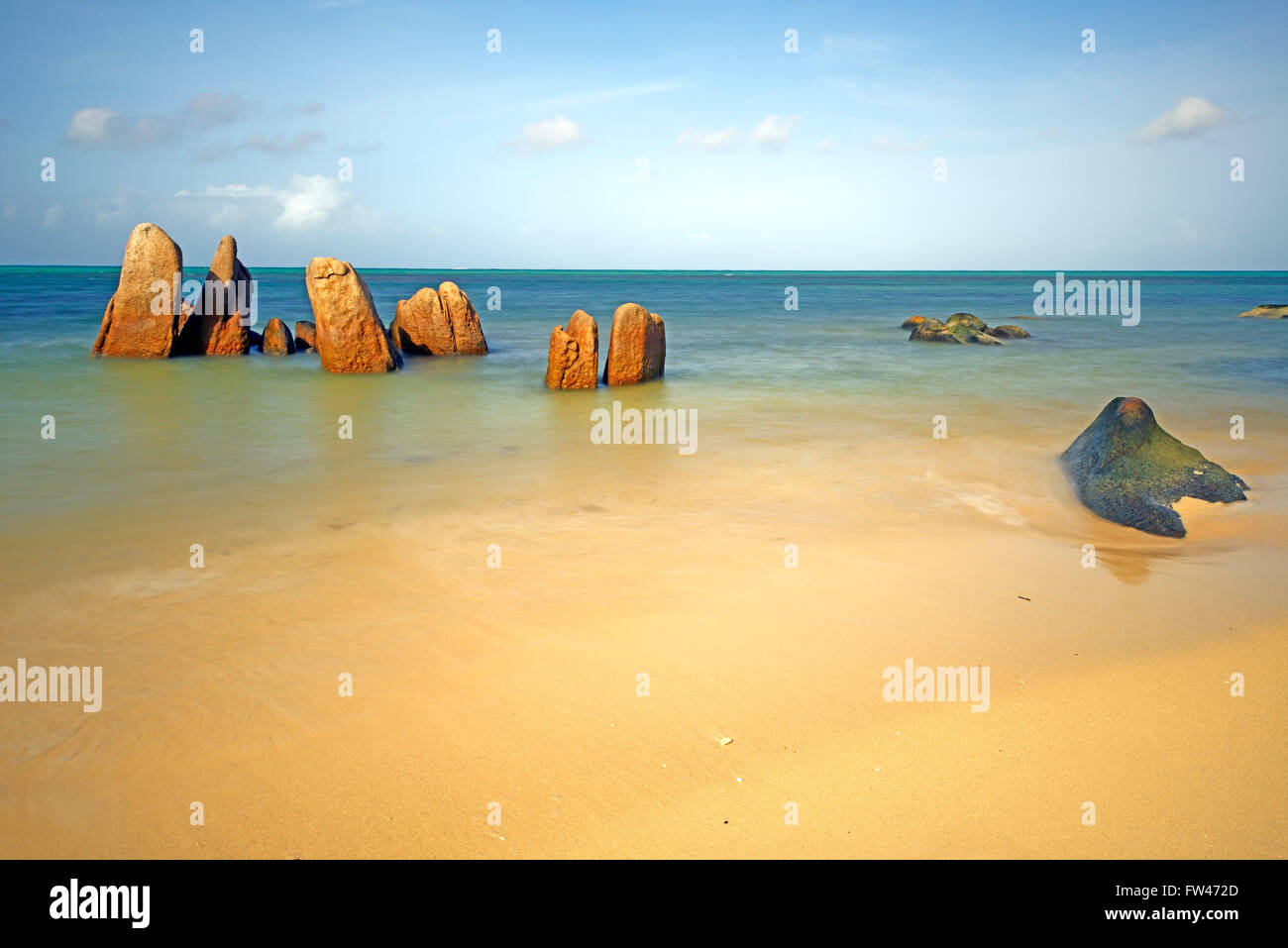 Granitfelsen im Meer am fruehen Morgen, Langzeitbelichtung, Grand Anse, Insel Praslin, Seychellen Stock Photo