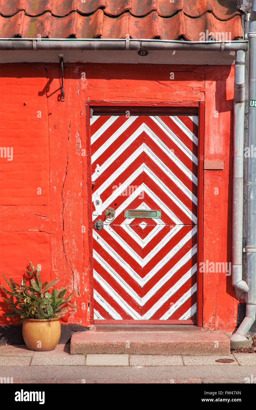Image of red house with unique, stripy door. Helsingor, Denmark. Stock Photo