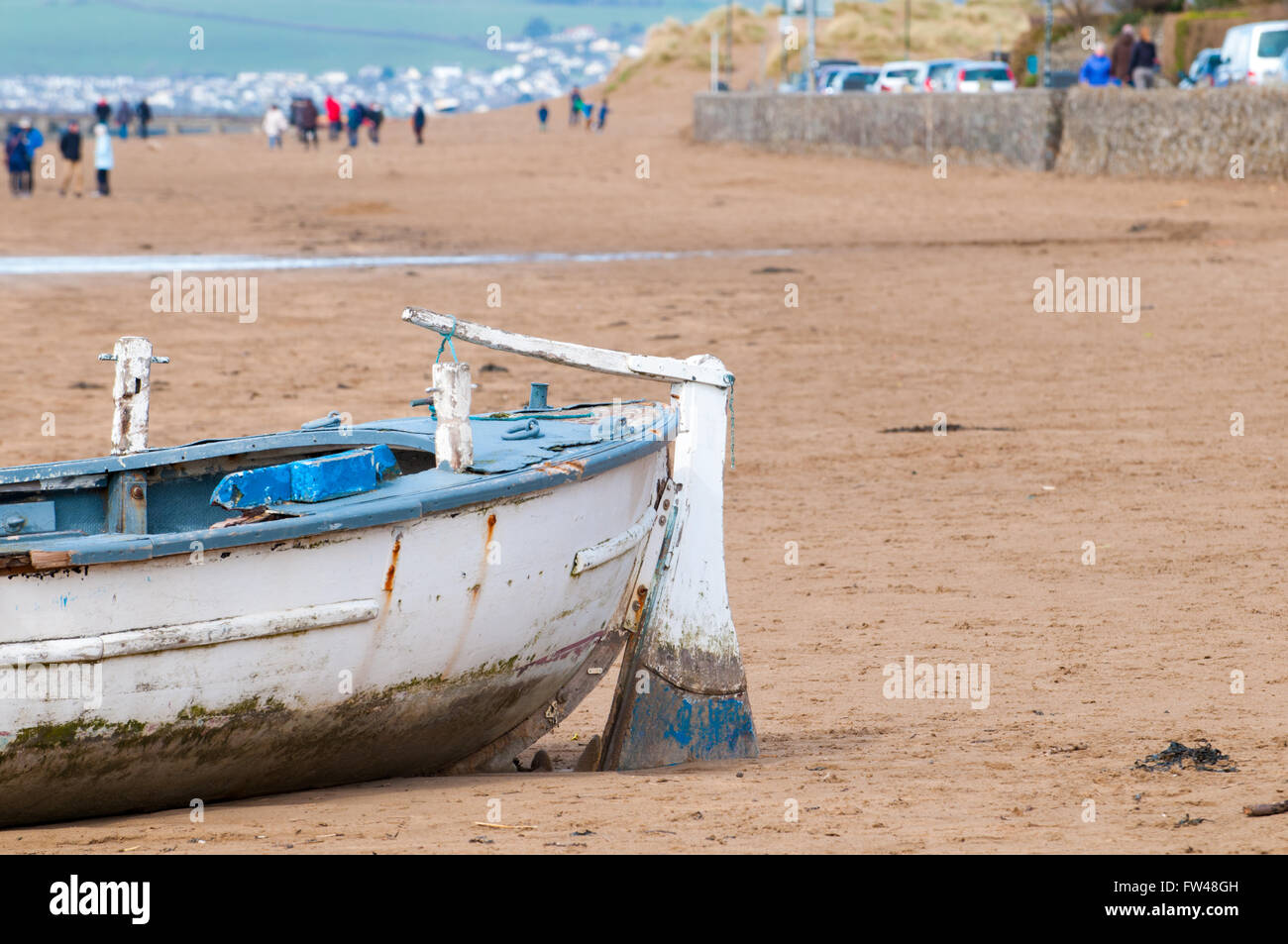 An old fishing boat moored on the beach at low tide Stock Photo - Alamy
