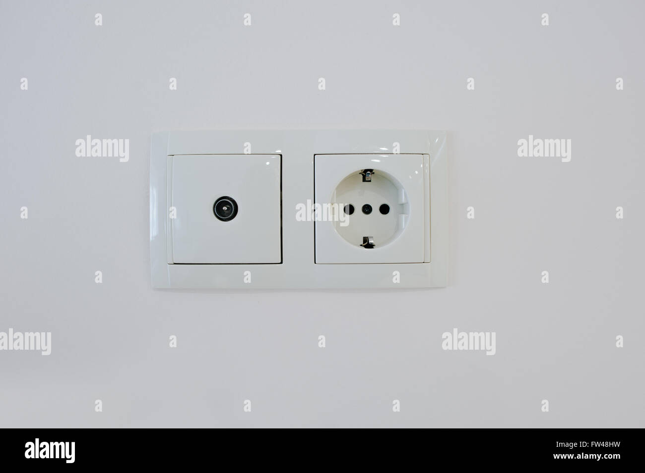 Twin electric socket with tv plug at the wall Stock Photo Alamy