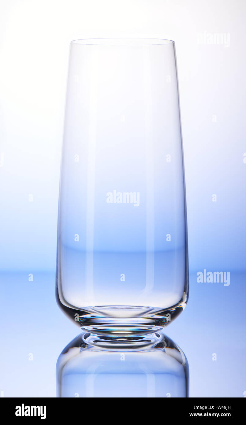 Empty drinking glass with reflection on white and blue background Stock Photo