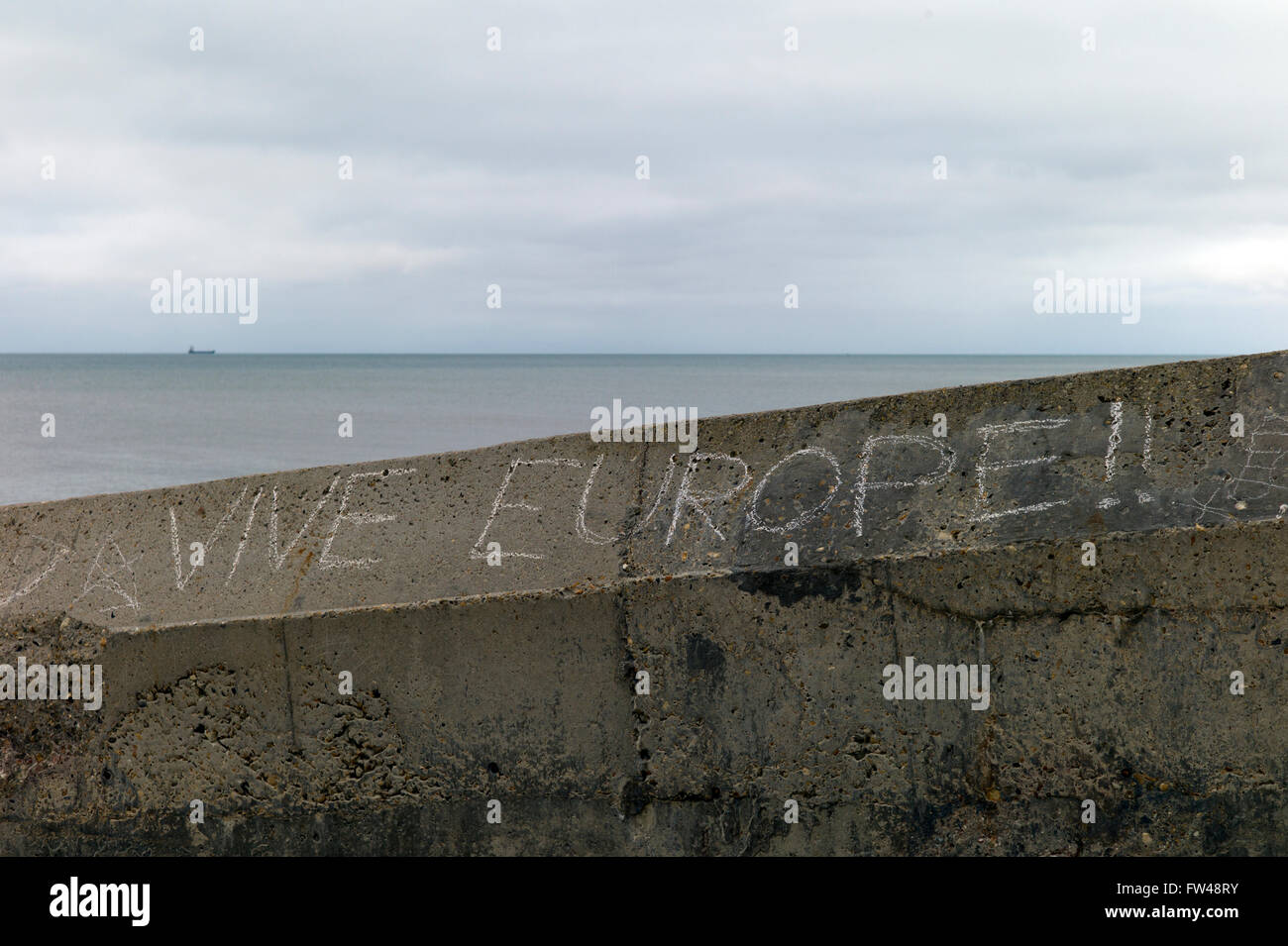 Chalk graffiti on seaside groyne, 'Vive Europe' Stock Photo