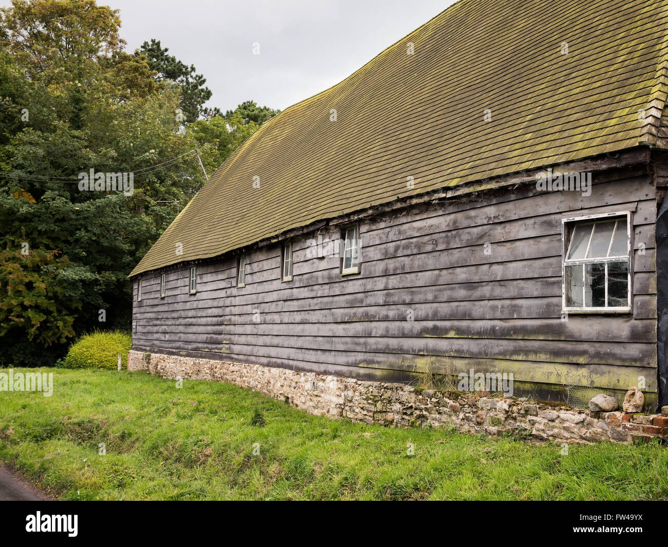 A large traditional wooden barn in an English village. Stock Photo
