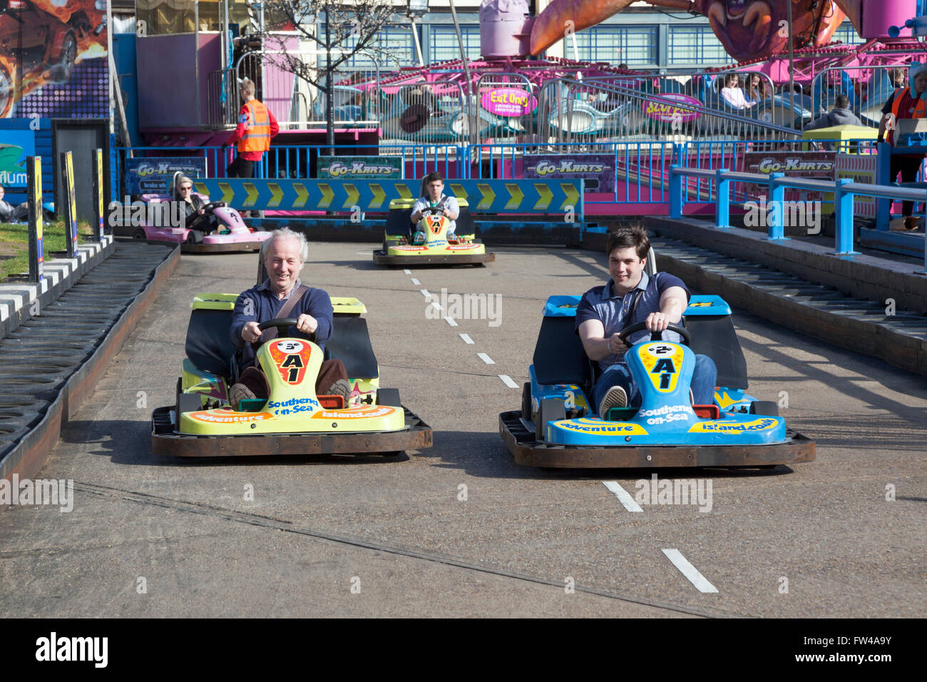 Grandfather and grandson competing in go karts Stock Photo