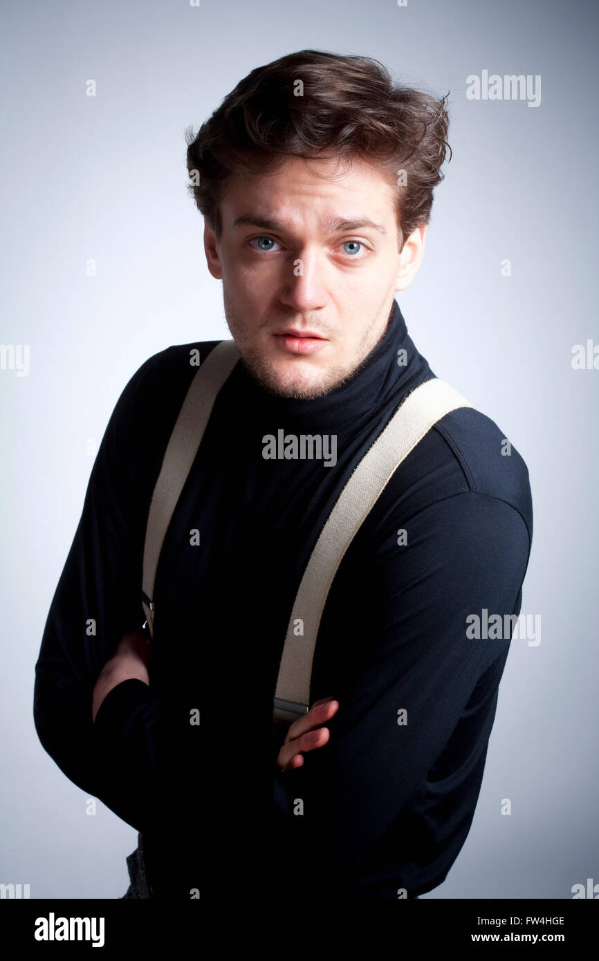 Portrait of a Young Man with Brown Hair with Suspenders. Stock Photo